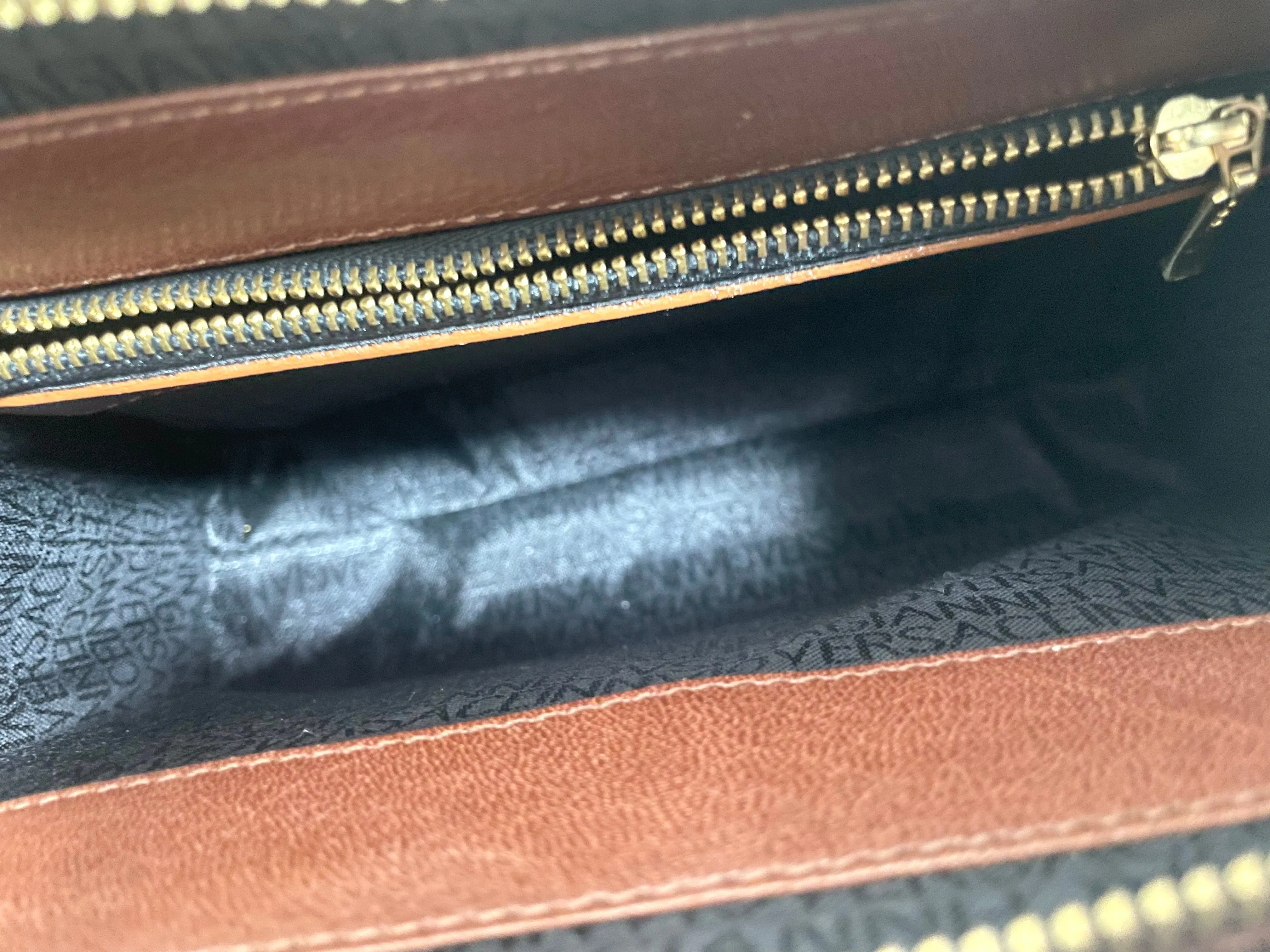Vintage Gianni Versace brown leather wristlet, purse clutch, case bag with its iconic golden sunburst charms. Unisex bag. 061027y1