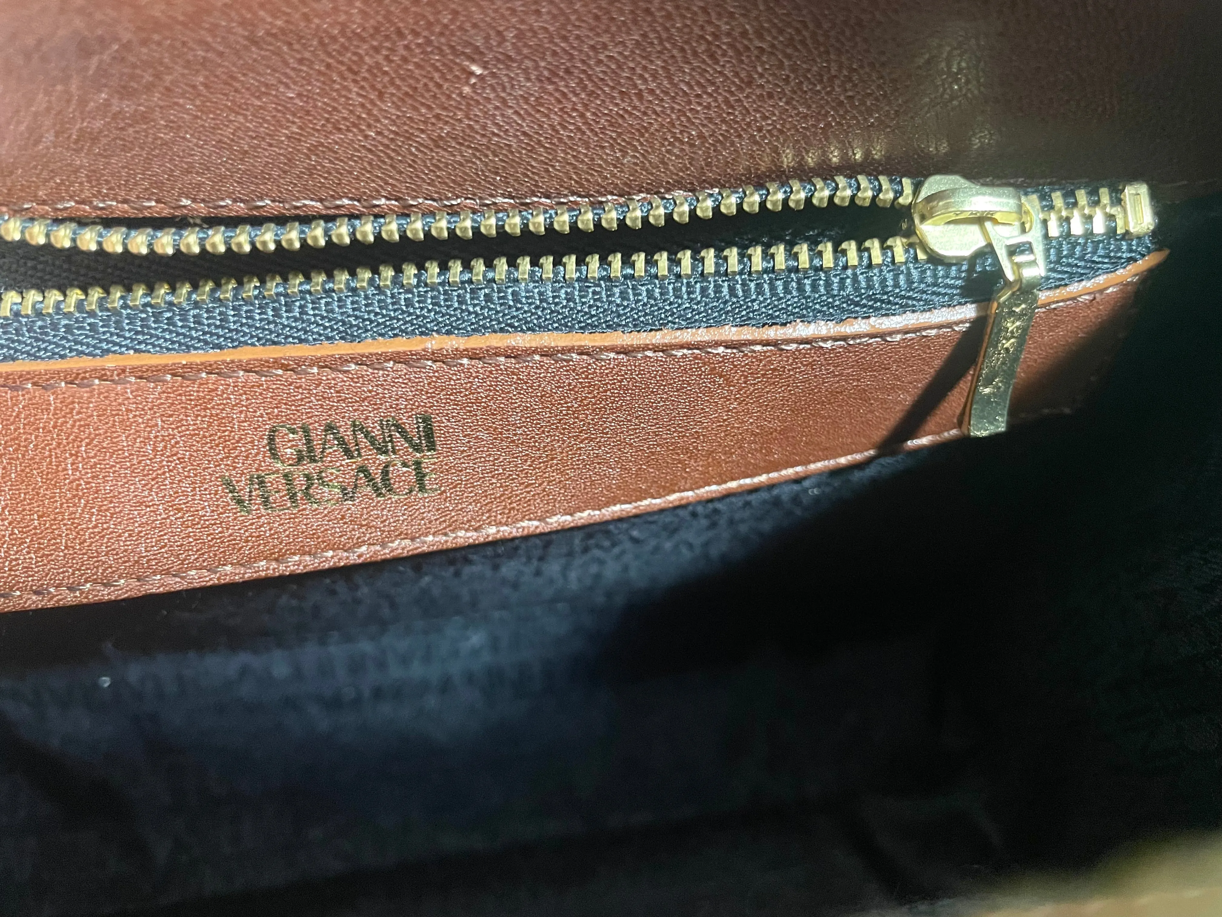 Vintage Gianni Versace brown leather wristlet, purse clutch, case bag with its iconic golden sunburst charms. Unisex bag. 061027y1
